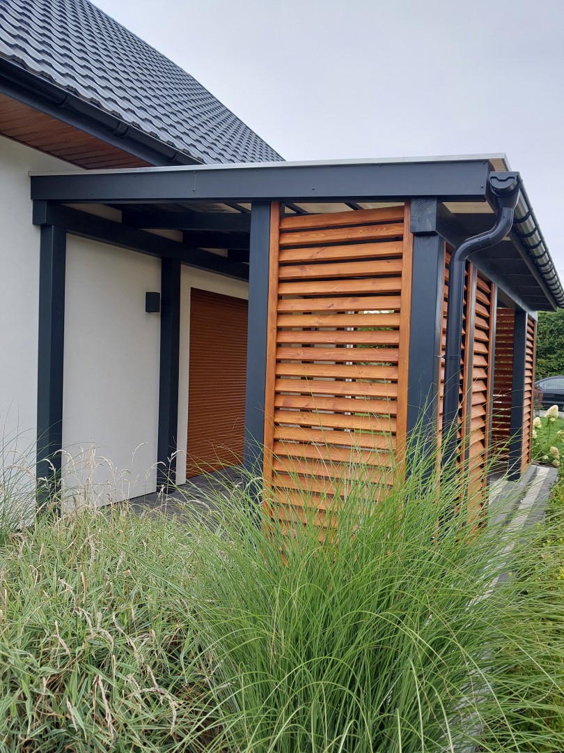 Zadaszenie tarasu z poliwęglanu z drewnianymi lamelami.
